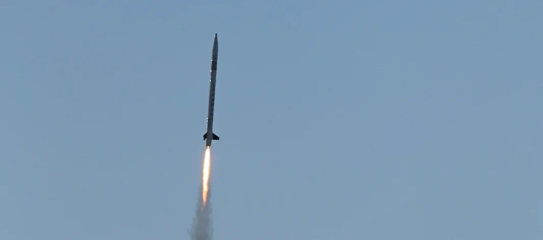 Lazarus ascending under power against a clear sky.