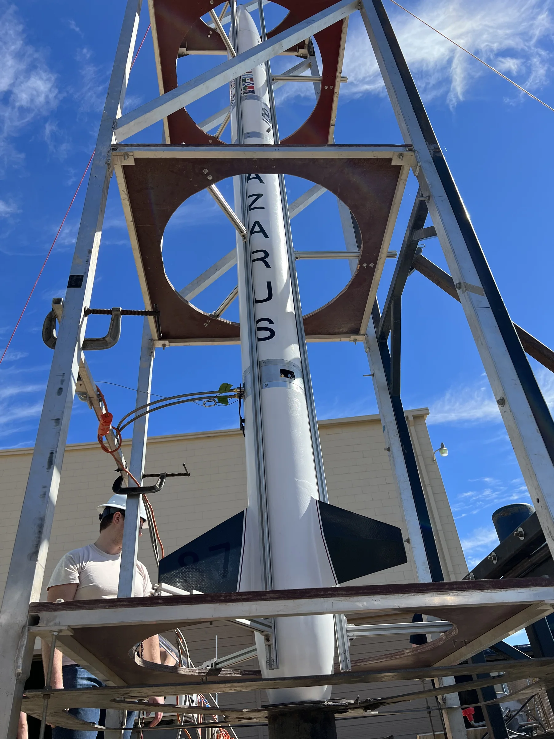 Lazarus integrated vertically in the launch tower under a blue sky.